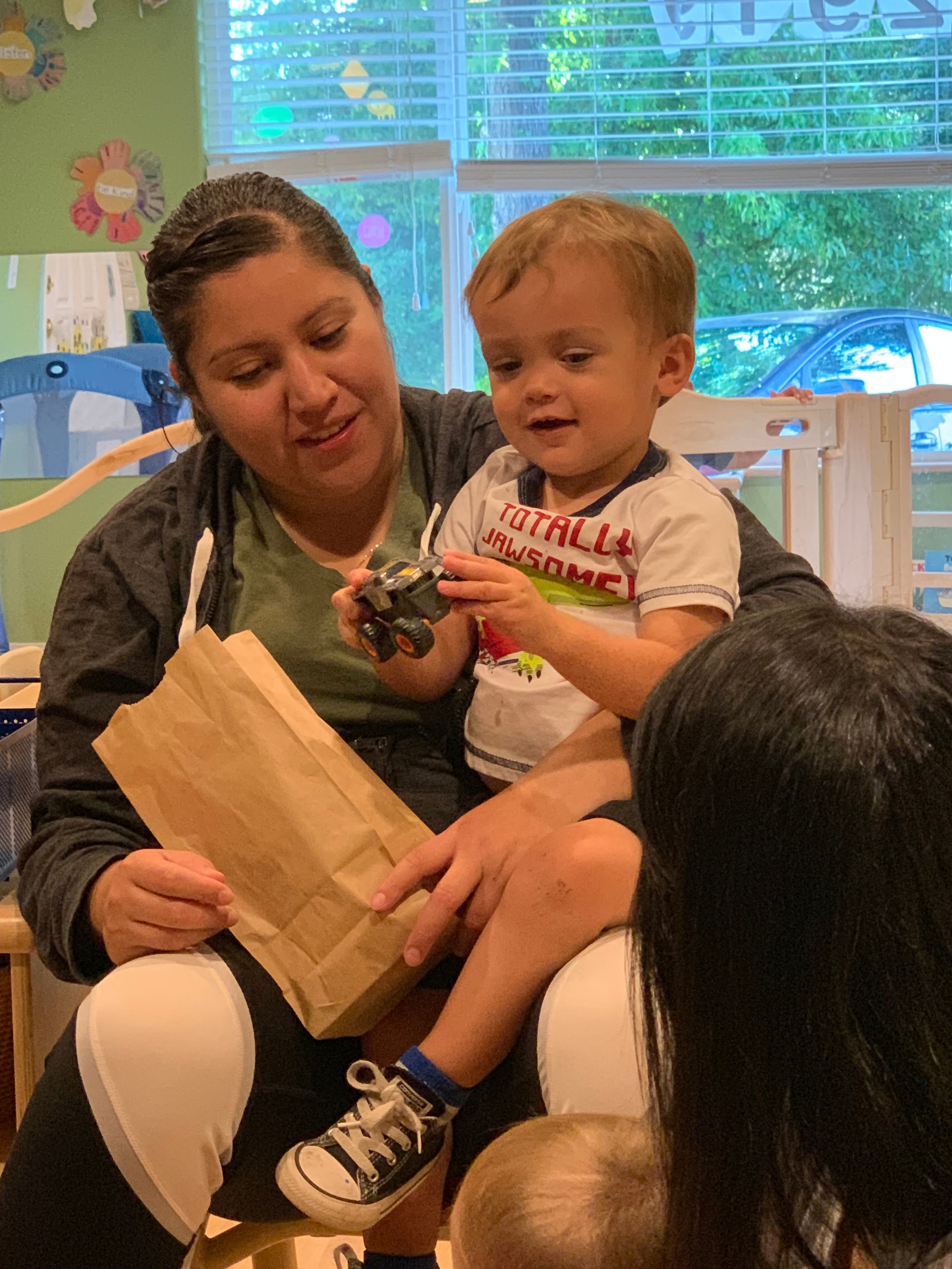 Caregiver nurturing an infant in a warm daycare setting
